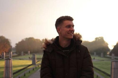 Travis Brubaker standing in a park